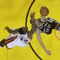 Miami Heat forward Udonis Haslem (40) fouls San Antonio Spurs  guard Manu Ginobili (20) of Argentina during the second half of Game 1 of the NBA Finals basketball game, Thursday, June 6, 2013 in Miami. The Spurs defeated the Heat 92-88.  (AP Photo/Lynne Sladky)