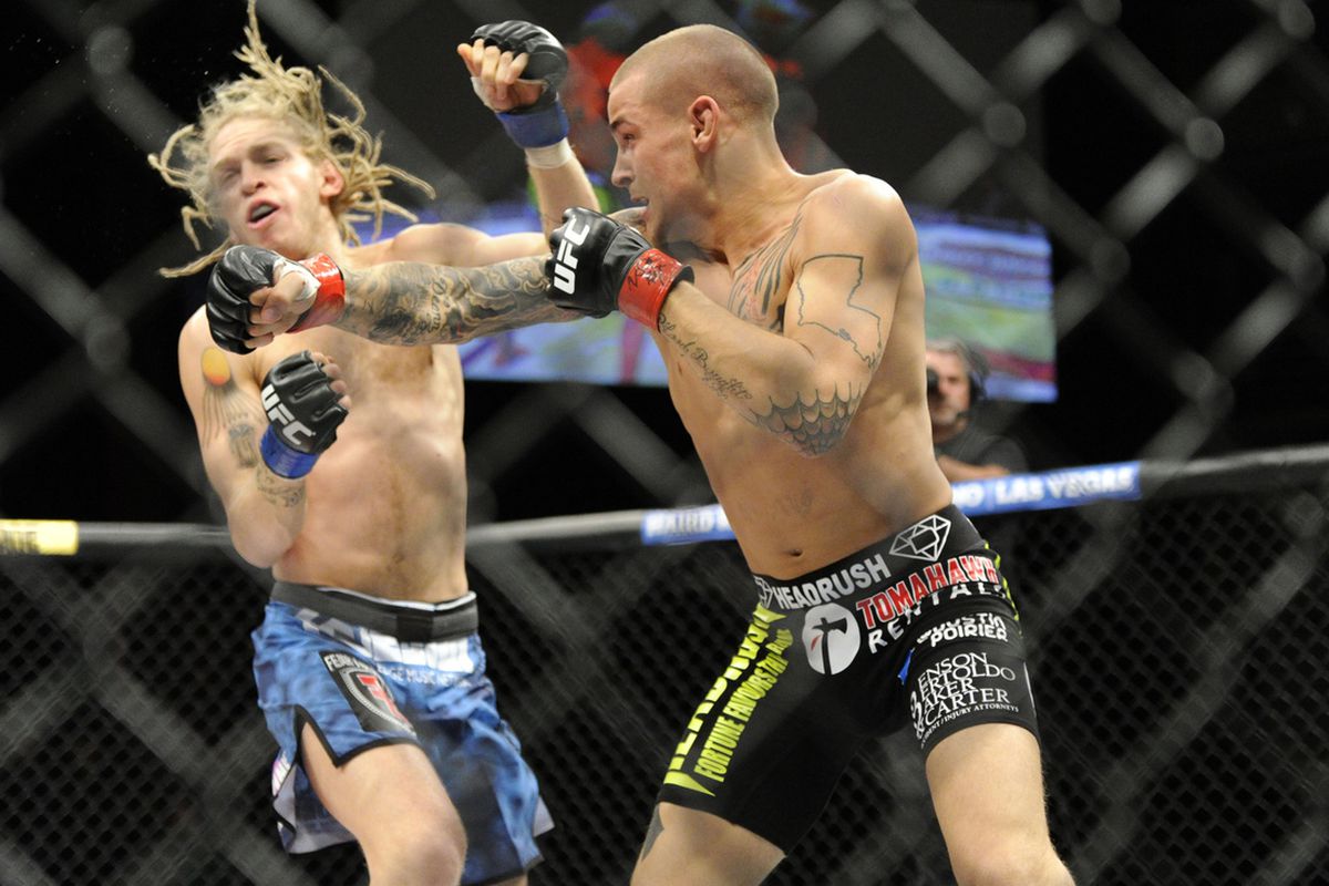 Dustin Poirier (right) punches Jonathan Brookins (left) at the TUF 16 Finale last night