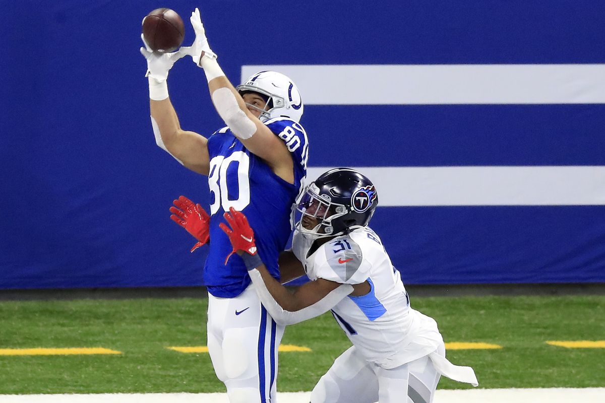 Trey Burton #80 of the Indianapolis Colts brings in a touchdown pass in the first quarter against Kevin Byard #31 of the Tennessee Titans during their game at Lucas Oil Stadium on November 29, 2020 in Indianapolis, Indiana.