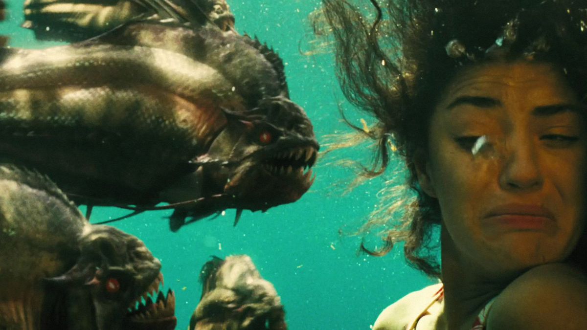 Kelly (Jessica Szohr) flinching away from a swarm of piranha in Piranha 3D.