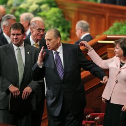 Thomas S. Monson, President of the Church of Jesus Christ of Latter-day Saints, with his daughter, Ann M. Dibb, sends a kiss to a friend at the end of the morning session of the 183rd Semiannual General Conference of the Church of Jesus Christ of Latter-day Saints Sunday, Oct. 6, 2013, in Salt Lake City.