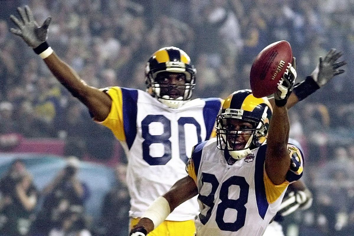 St. Louis Rams WR Torry Holt and WR Isaac Bruce celebrate Holt’s touchdown catch during the second half of Super Bowl XXXIV, Jan. 30, 2000.