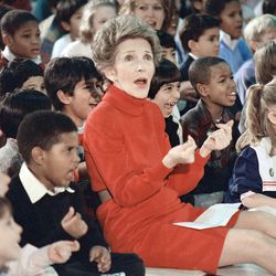 FILE - In this Feb. 26, 1987 file photo, then first lady Nancy Reagan watches an anti-drug musical titled "Just Say No," performed by teenage students from the Chantilly, Va., High School Drama Department at the Cameron Elementary School in Alexandria, Va. The helpmate, backstage adviser and fierce protector of Ronald Reagan in his journey from actor to president _ and finally during his battle with Alzheimer's disease - died Sunday, March 6, 2016, at the age of 94. 