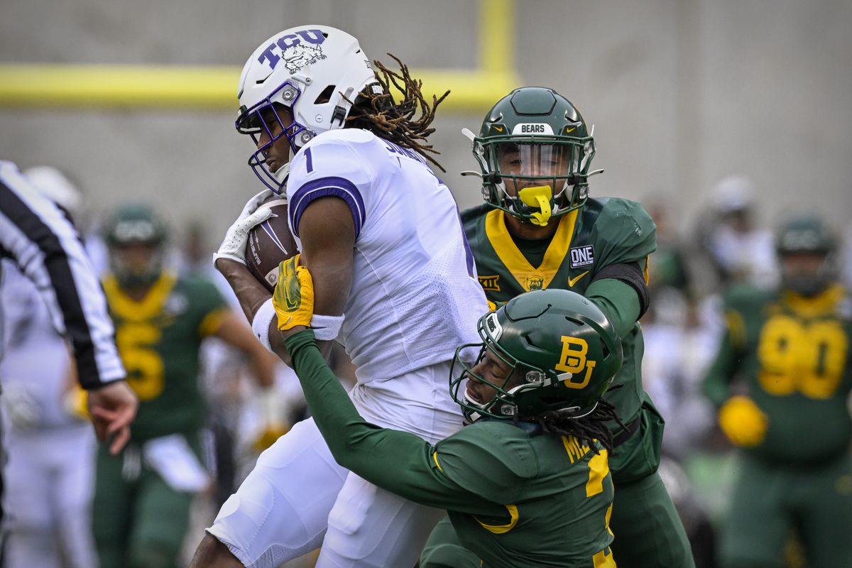 TCU Horned Frogs wide receiver Quentin Johnston catches a pass for a first down against the Baylor Bears as cornerback Mark Milton defends during the first quarter at McLane Stadium.