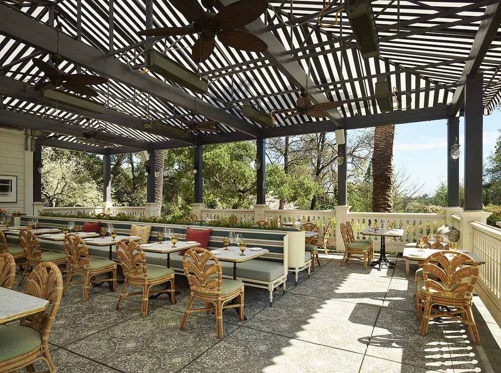 The covered Palm Terrace with low tables and banquettes.