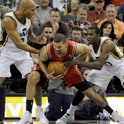 Houston Rockets shooting guard Francisco Garcia (32) fights his way to the basket between Utah Jazz small forward Richard Jefferson (24) and Utah Jazz small forward Jeremy Evans (40) during a game at EnergySolutions Arena on Monday, Dec. 2, 2013.