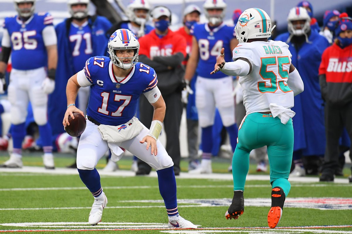 Buffalo Bills quarterback Josh Allen (17) avoids the pressure of Miami Dolphins outside linebacker Jerome Baker (55) during the second quarter at Bills Stadium.