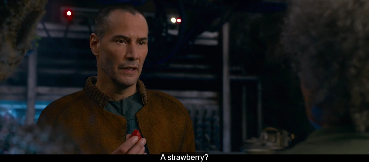 Keanu Reeves’ Neo says “A strawberry?” in the post-apocalyptic city of IO in The Matrix Resurrections
