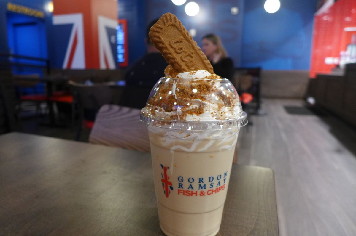 A milkshake with a cookie sticking out of the top.