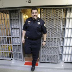 Warden Scott Crowther walks out of a cell in Wasatch A-East block during a media tour Thursday, Feb. 26, 2015, at the Utah State Prison in Draper. Gov. Gary Herbert said Thursday that he's opposed to the idea of allowing a state commission to pick a location to build a new prison instead of leaving the decision with the Legislature. 