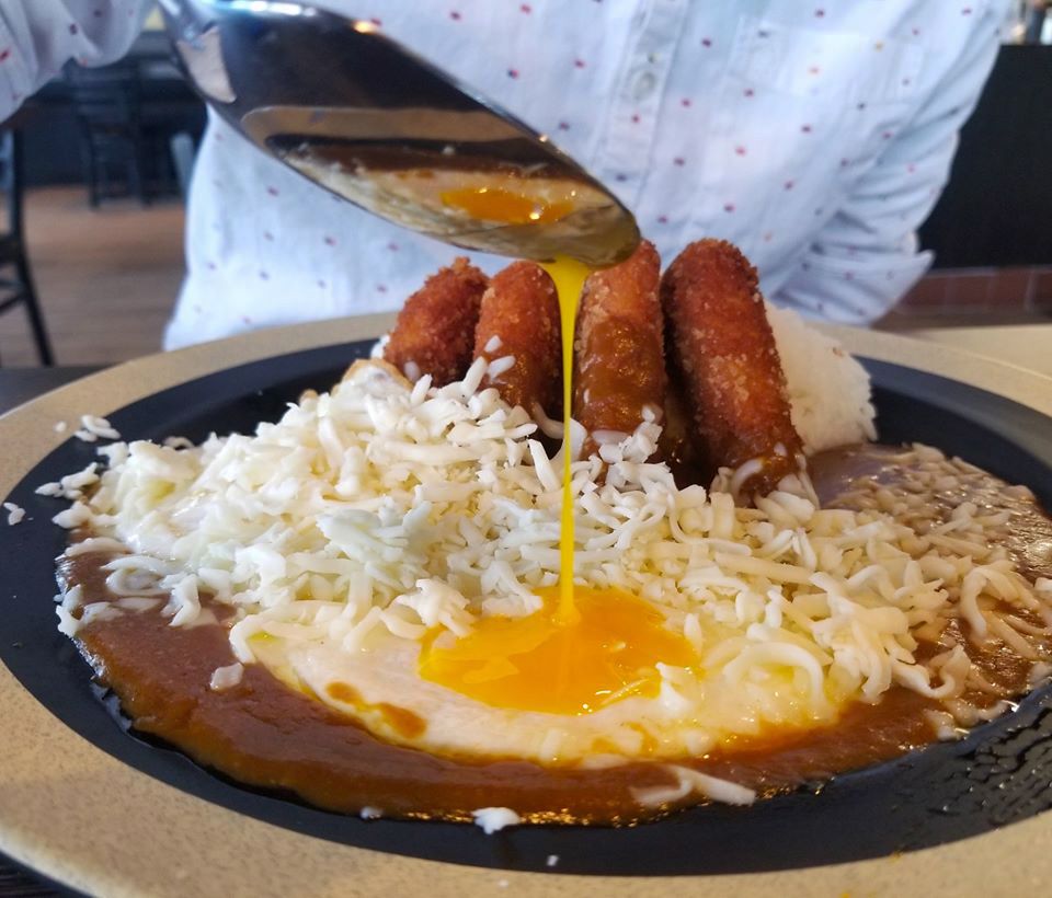 A katsu curry dish topped with a fried egg, available for takeout and delivery Zen Curry Dining.