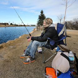 Easton Monsen braves cold temperatures Sunday, Feb. 22, 2015, as he fishes at the pond at Herriman Springs.