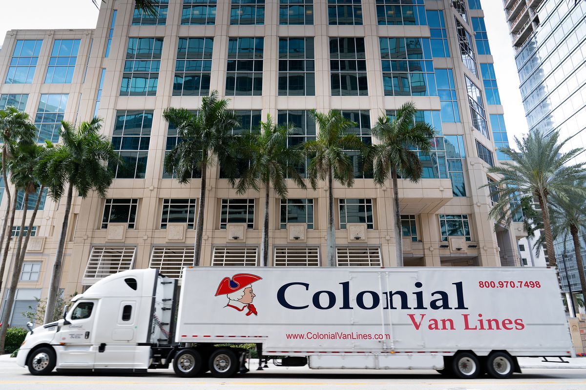 Colonial Van Lines truck in front of a building