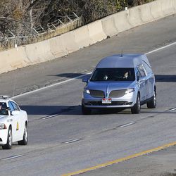 The patrol car of Utah Highway Patrol trooper Eric Ellsworth, leads the procession as his body is transported on I-80 west from the Utah State Medical Examiner's office in Salt Lake City to Lindquist Mortuary in Ogden on Friday, Nov. 25, 2016.