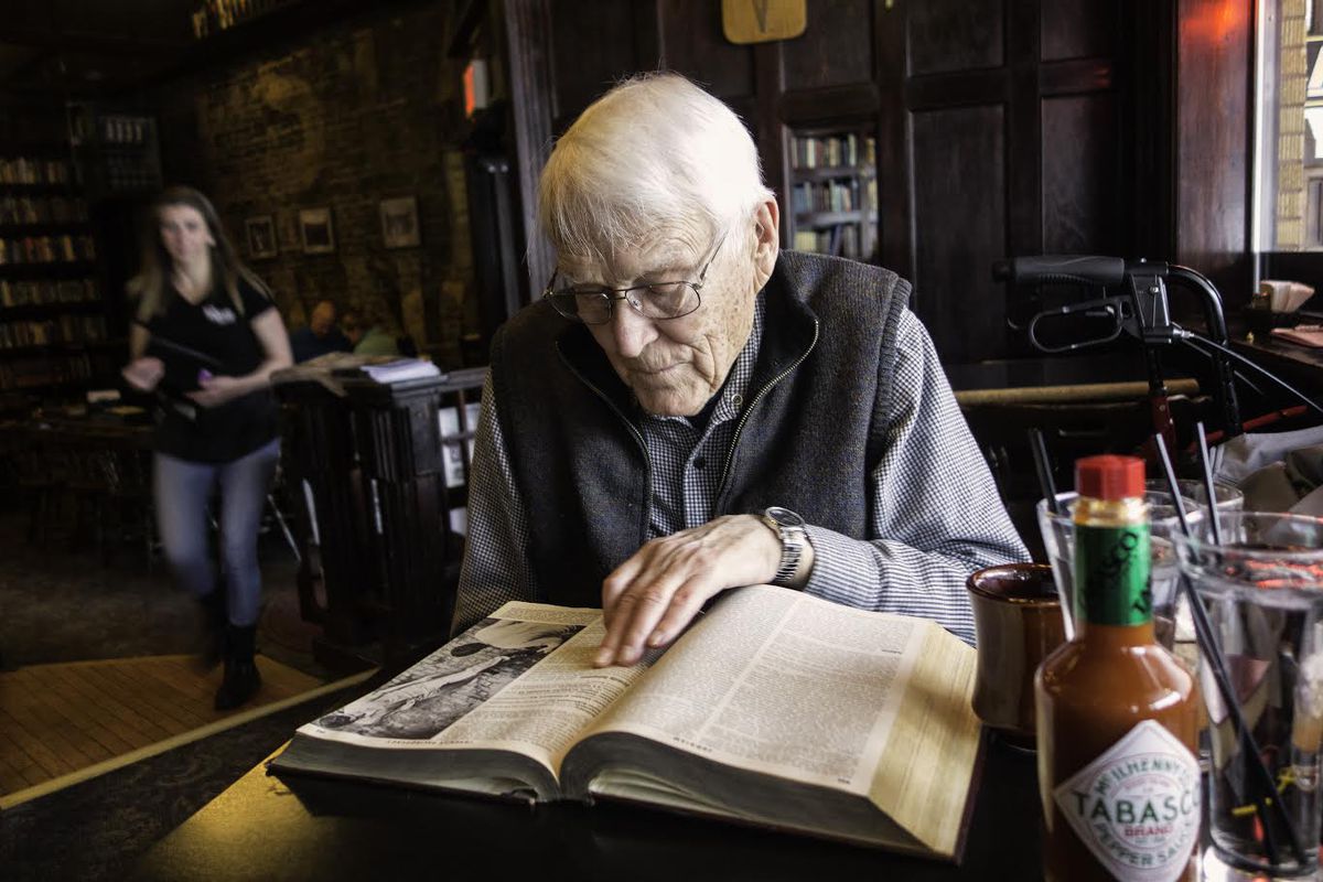 James Short looks up his entry on Juvenile Delinquency in an early 1960s edition of the Encyclopedia Britannica while enjoying breakfast at Rico’s Public House, January 8, 2017 in Pullman, Washington.| J. Michael Short photo