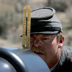 Val Spruell, a Civil War re-enactor from Vernal, checks the sights on his Type 5 12-pounder Napoleon cannon before firing it during a demonstration Sunday, April 14, 2013, at the Buckskin Hills Complex in Uintah County.