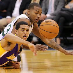 Los Angeles Lakers guard Jordan Clarkson (6) and Utah Jazz guard Elijah Millsap (13) try to chase down a loose ball as the Jazz and the Lakers play Wednesday, Feb. 25, 2015, at EnergySolutions Arena in Salt Lake City.