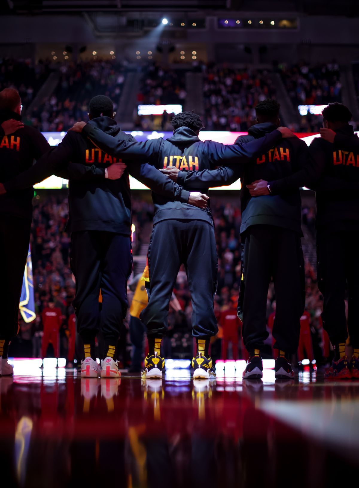 Utah Jazz guard Donovan Mitchell (45), center, and teammates stand together during the national anthem before the game against the Miami Heat at Vivint Arena in Salt Lake City on Saturday, Nov. 13, 2021.