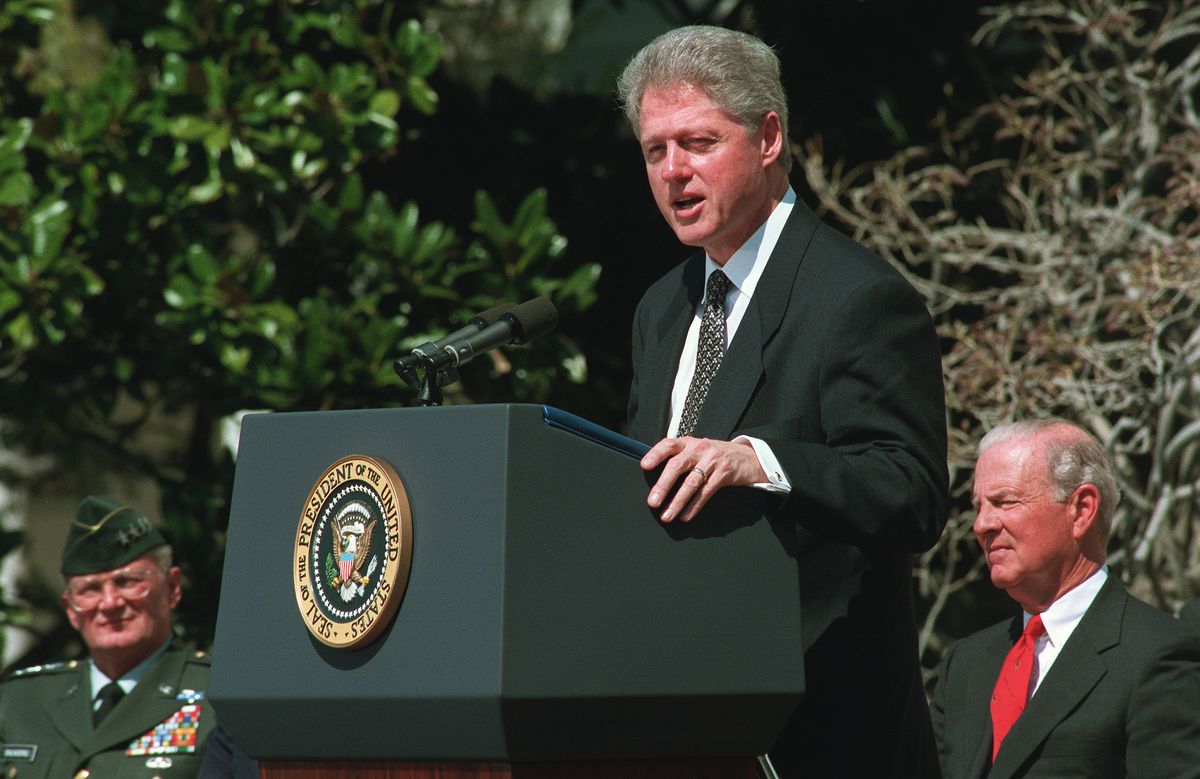 President Bill Clinton standing at a lectern outdoors at the White House.