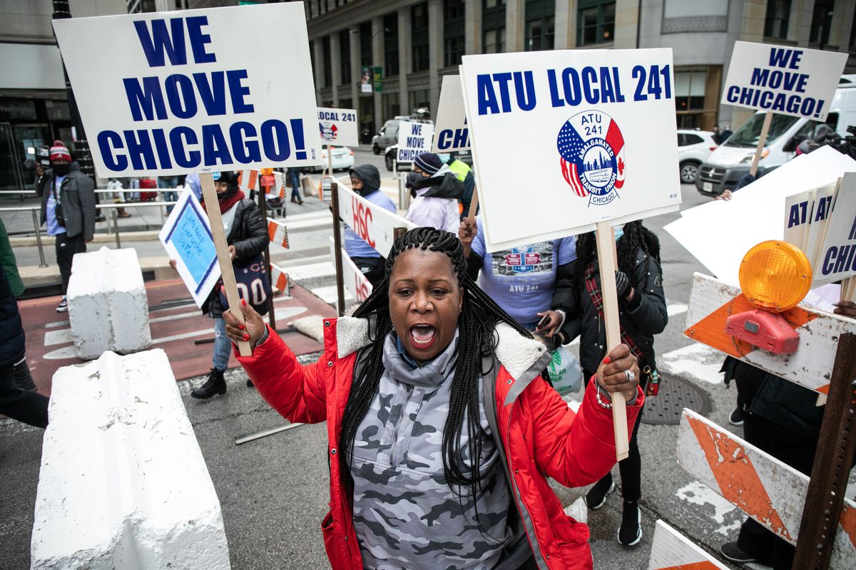 Kaleah Jones, a bus operator for five years, in red, marches with Chicago Transit Authority bus operators, Amalgamated Transit Union 241 members and their allies to Millennium Park in the Loop, Saturday morning, Dec. 11, 2021 to demand the city to protect transit workers. This is in response to what they say is an increased number of assaults against bus operators in the city.