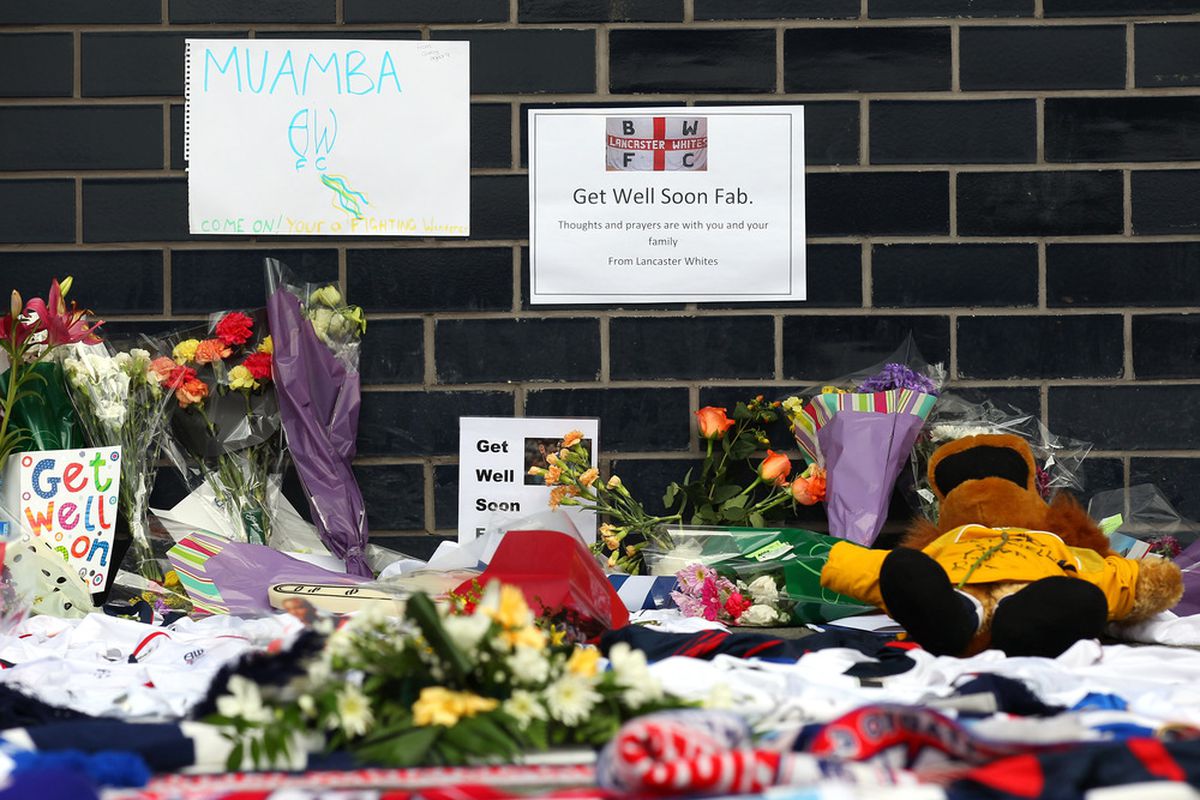 BOLTON, ENGLAND - MARCH 19:  Tributes and get well messages are laid outside the Reebok Stadium for Bolton Wanderers' Fabrice Muamba at Reebok Stadium on March 19, 2012 in Bolton, England.  (Photo by Alex Livesey/Getty Images)