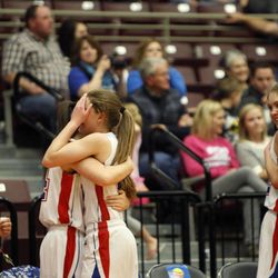 Panguitch players hug each during the girls 1A basketball championship at the Sevier Valley Center in Richfield Saturday, Feb. 21, 2015. Panguitch beat Piute, 58-28.