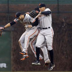 From left, San Francisco Giants' Gregor Blanco, Angel Pagan and Hunter Pence celebrate their 7-6 win over the Chicago Cubs in a baseball game in Chicago, Thursday, April  11, 2013. 