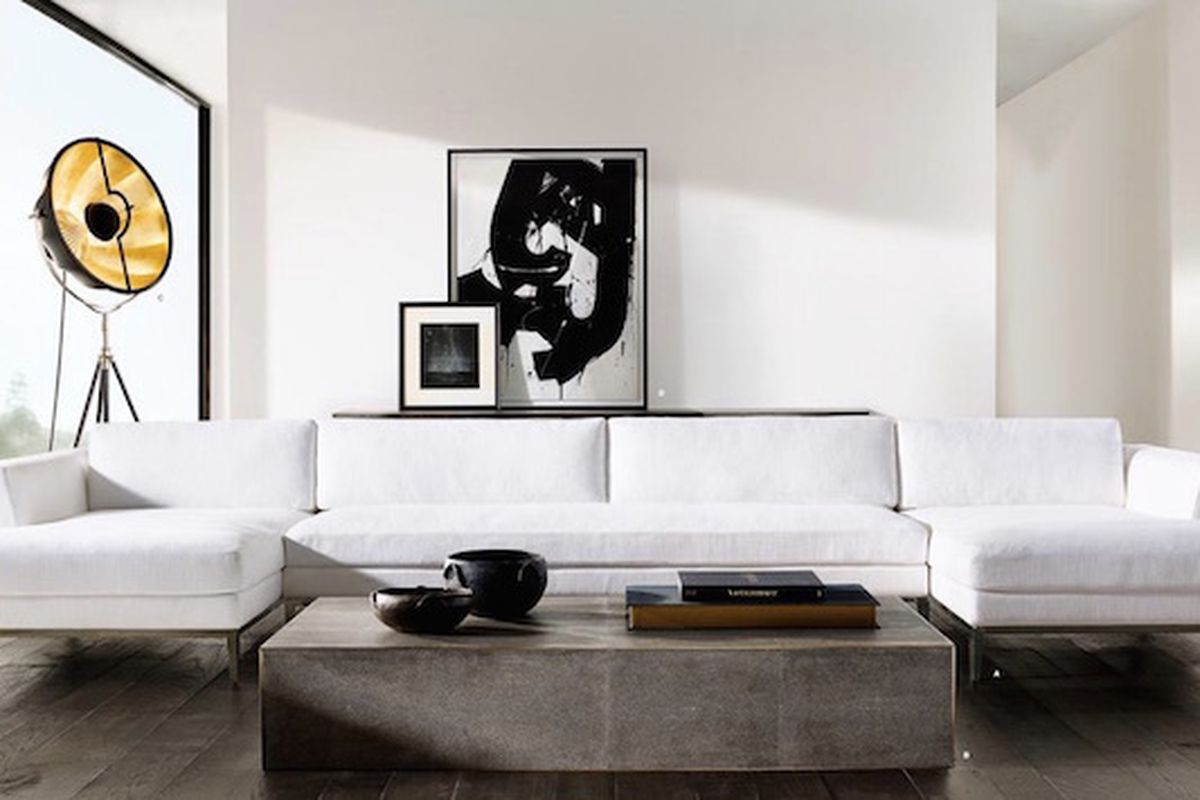 Pieces from the new RH Modern line, including the Italia Taper Arm Sectional, the Shagreen Cube Rectangular Coffee Table, and the Fortuny Studio 76 Floor Lamp.