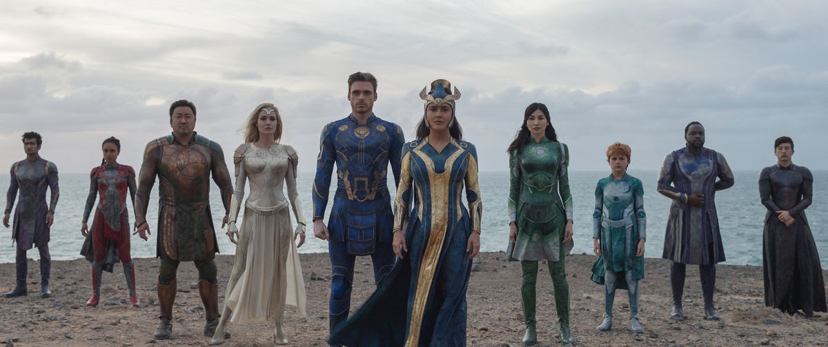 The Eternals are assembled on a beach in a scene from Marvel’s Eternals.