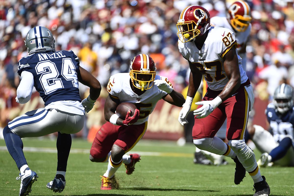 Washington running back Chris Thompson carries the ball as Dallas Cowboys cornerback Chidobe Awuzie defends during the first half at FedExField.