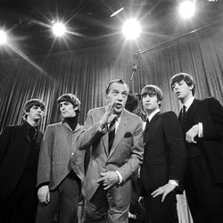 Ed Sullivan, center, stands with The Beatles during a rehearsal for the British group's first American appearance, on the "Ed Sullivan Show," in New York on Feb. 8, 1964. From left: Ringo Starr, George Harrison, Sullivan, John Lennon and Paul McCartney. The rock 'n' roll band known as "The Fab Four" was seen by 70 million viewers. "Beatlemania" swept the charts with twenty No. 1 hits and more than 100 million records sold. The Beatles broke up in 1970.