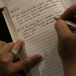 Shari takes notes of her daughters' thoughts while discussing scripture during their morning routine at their Layton home on Friday, Nov. 30, 2018. Each morning Shari and her three daughters meet in the living room to read scripture, write in their journals and breathe deeply to clear their minds.