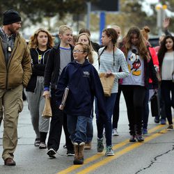 Students are escorted to reunite with their parents following a shooting incident at Mueller Park Junior High School in Bountiful on Thursday, Dec. 1, 2016.