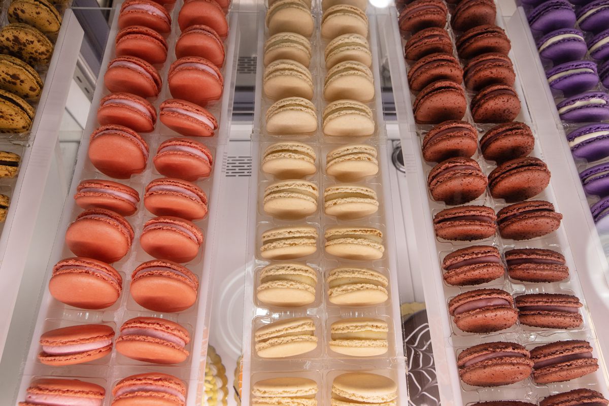 Six vertical rows of colorful French macarons.