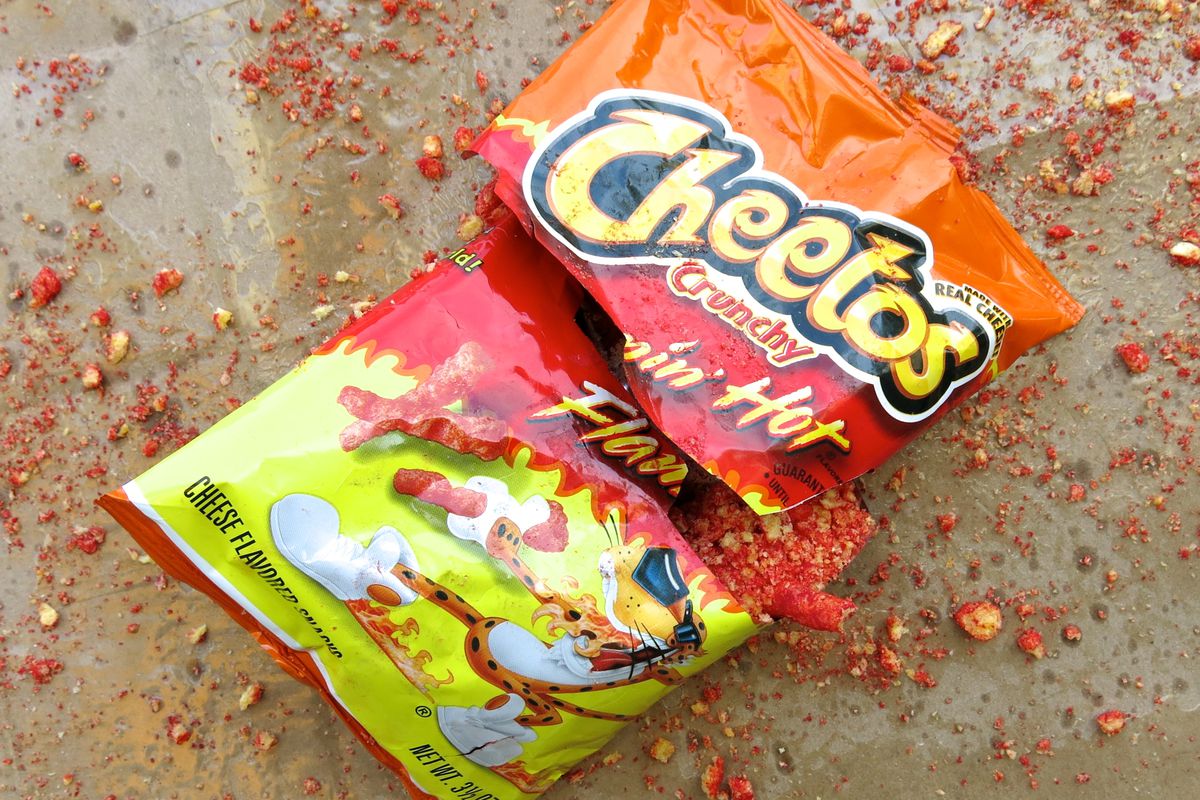 A bag of Flamin’ Hot Cheetos on a brown background