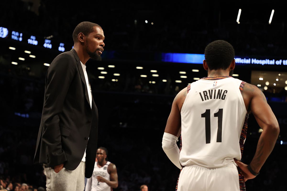 Kevin Durant of the Brooklyn Nets talks to Kyrie Irving of the Brooklyn Nets during their game against the Milwaukee Bucksat Barclays Center on January 18, 2020 in New York City.