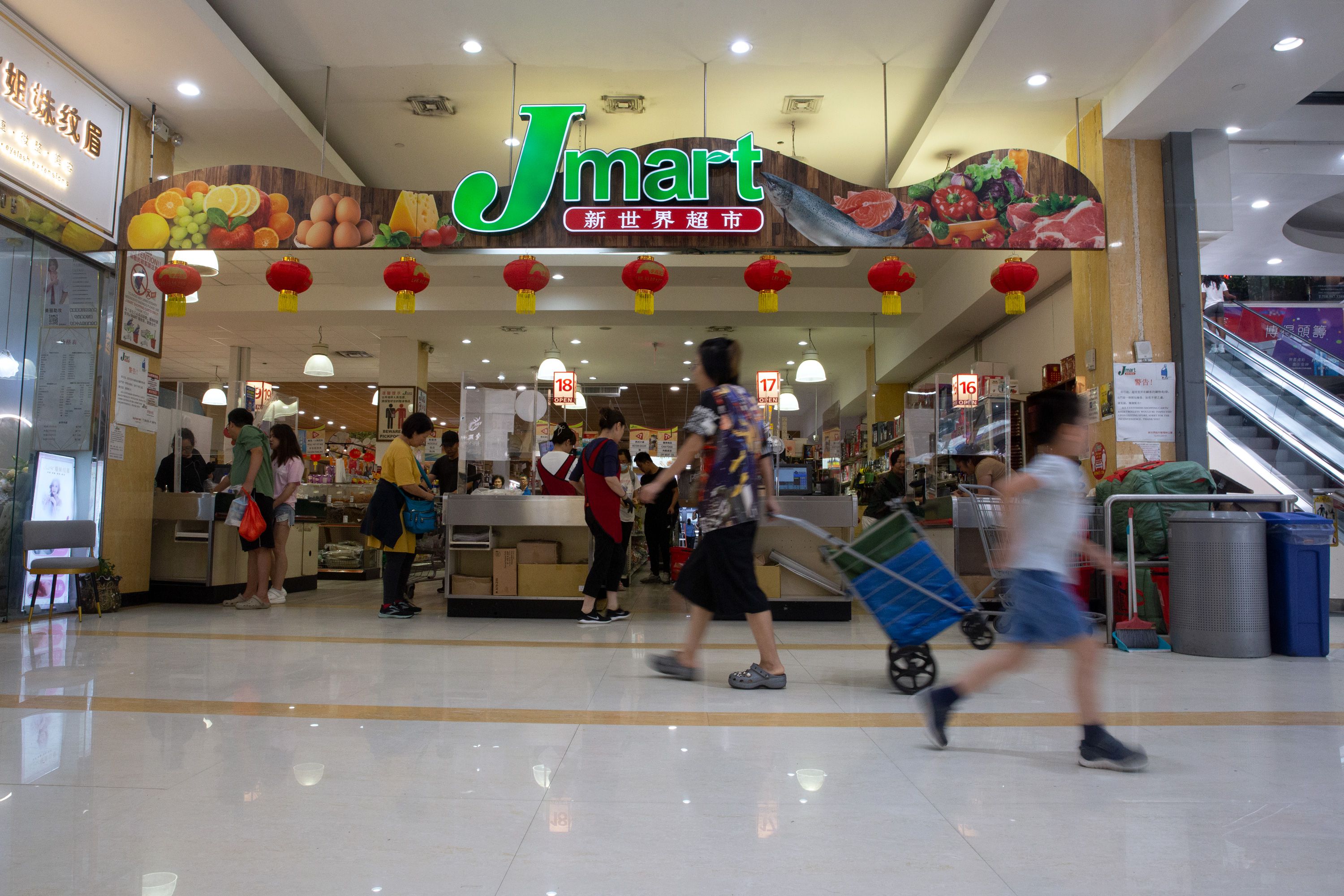 Shoppers get food at a Jmart in the New World Mall in Flushing.