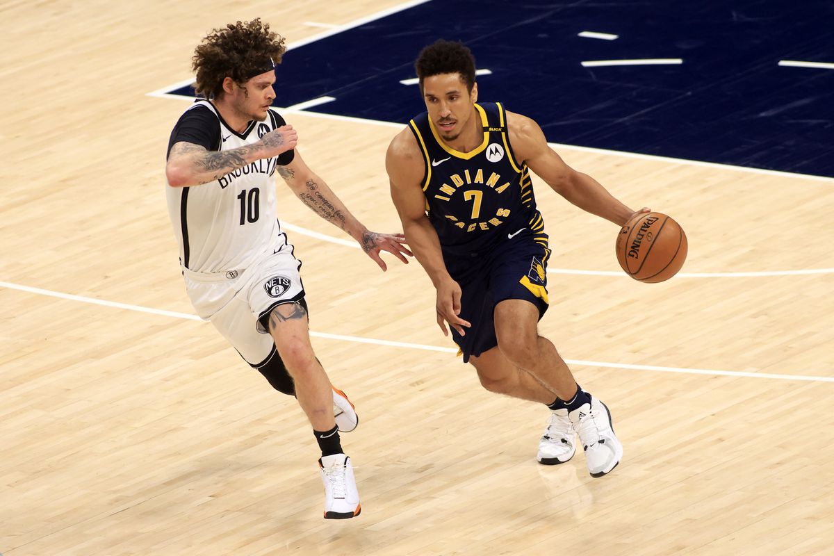 Malcolm Brogdon of the Indiana Pacers brings the ball up the court while guarded by Tyler Johnson of the Brooklyn Nets at Bankers Life Fieldhouse on April 29, 2021 in Indianapolis, Indiana.
