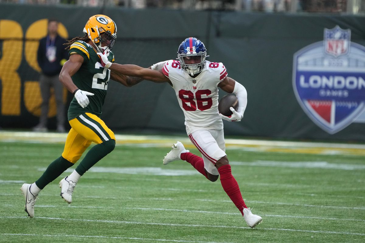 New York Giants wide receiver Darius Slayton (86) carries the ball as Green Bay Packers cornerback Eric Stokes (21) defends during an NFL International Series game at Tottenham Hotspur Stadium.