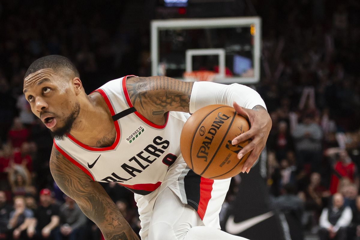 Portland Trail Blazers guard Damian Lillard is fouled as he drives to the basket during the second half against the Utah Jazz at Moda Center.