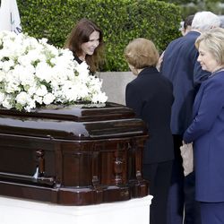 Patti Davis, left, greets Rosalynn Carter as Hillary Clinton looks at the casket during the graveside service for Nancy Reagan at the Ronald Reagan Presidential Library, Friday, March 11, 2016 in Simi Valley, Calif. 