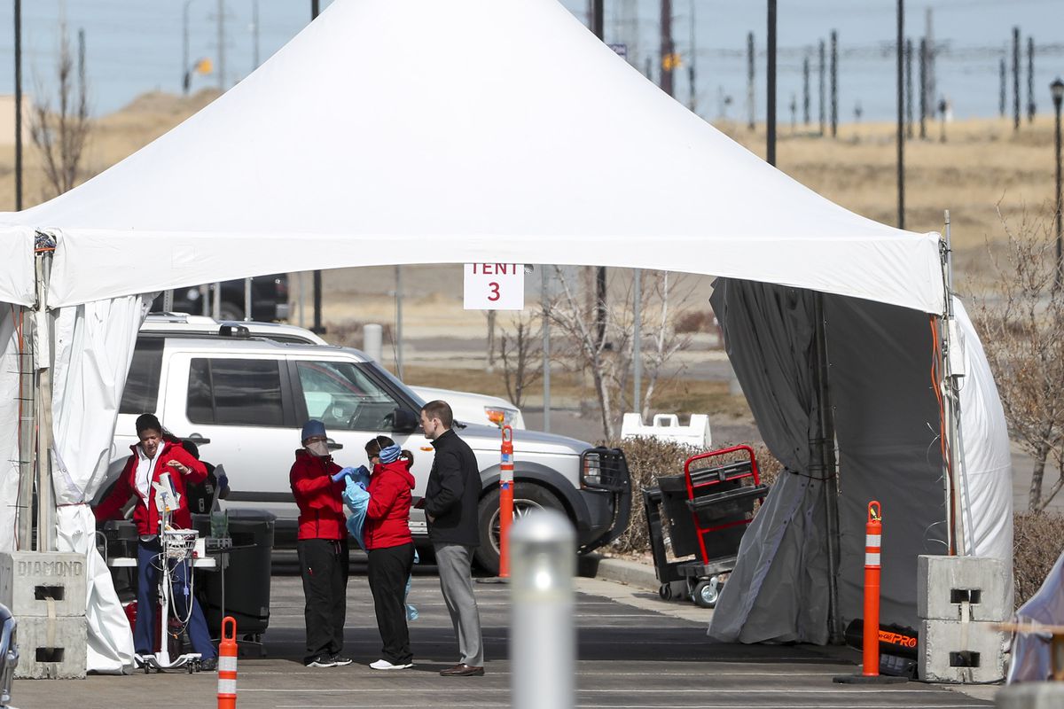 Hospital employees work at a drive-thru COVID-19 testing facility tent outside University of Utah Health’s South Jordan Health Center on Monday, March 16, 2020.
