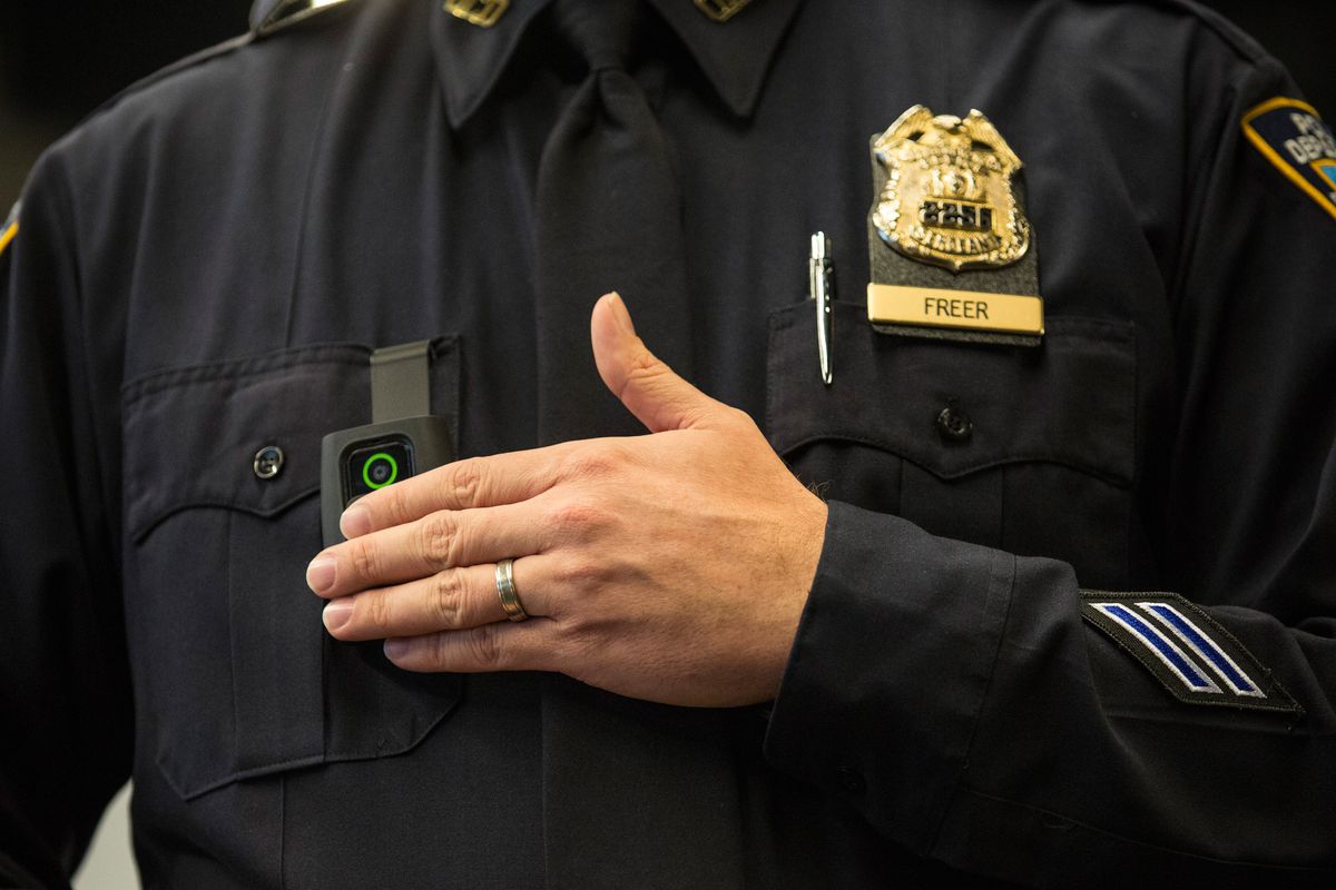 A New York City police officer dons a body camera.