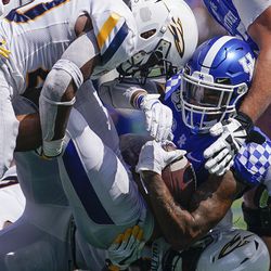 Kentucky running back Asim Rose (10) is tacked by several Toledo defenders during the second half of the NCAA college football game, Saturday, August 31, 2019, in Lexington, Ky. 