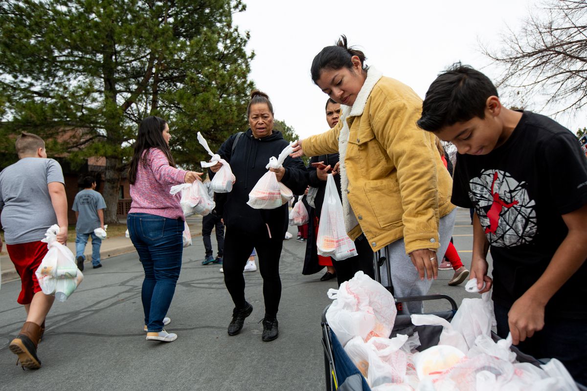 Mele Massey, center, collects the few donations left from the Utah Food Bank at the parking lot of a chapel belonging to The Church of Jesus Christ of Latter-day Saints in Taylorsville on Monday, March 16, 2020. Hundreds of people waited in line to receive the donations.