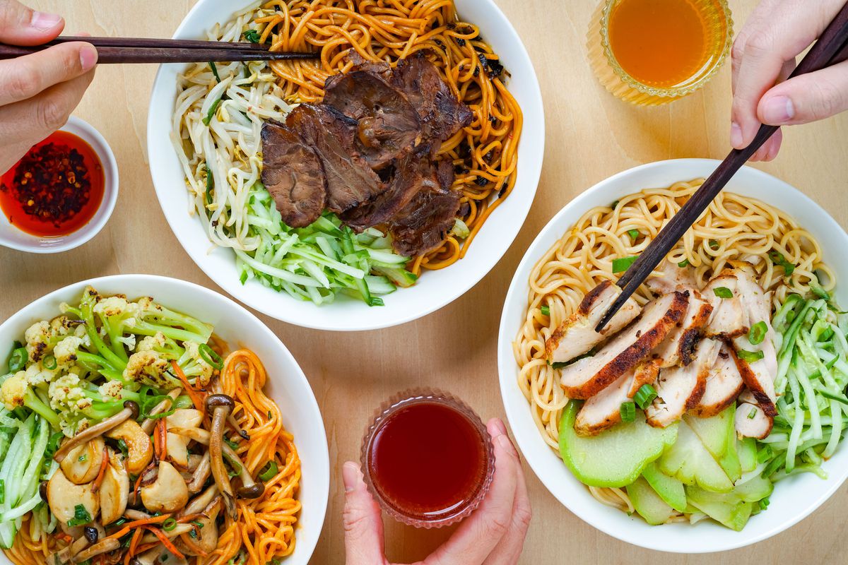 Three noodle bowls topped with various proteins