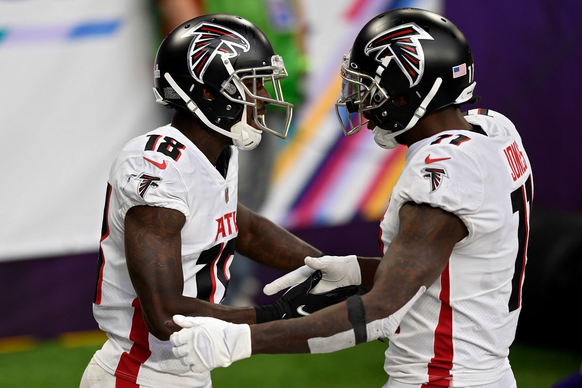Calvin Ridley #18 and Julio Jones #11 of the Atlanta Falcons celebrate after scoring a touchdown in the third quarter against the Minnesota Vikings at U.S. Bank Stadium on October 18, 2020 in Minneapolis, Minnesota.