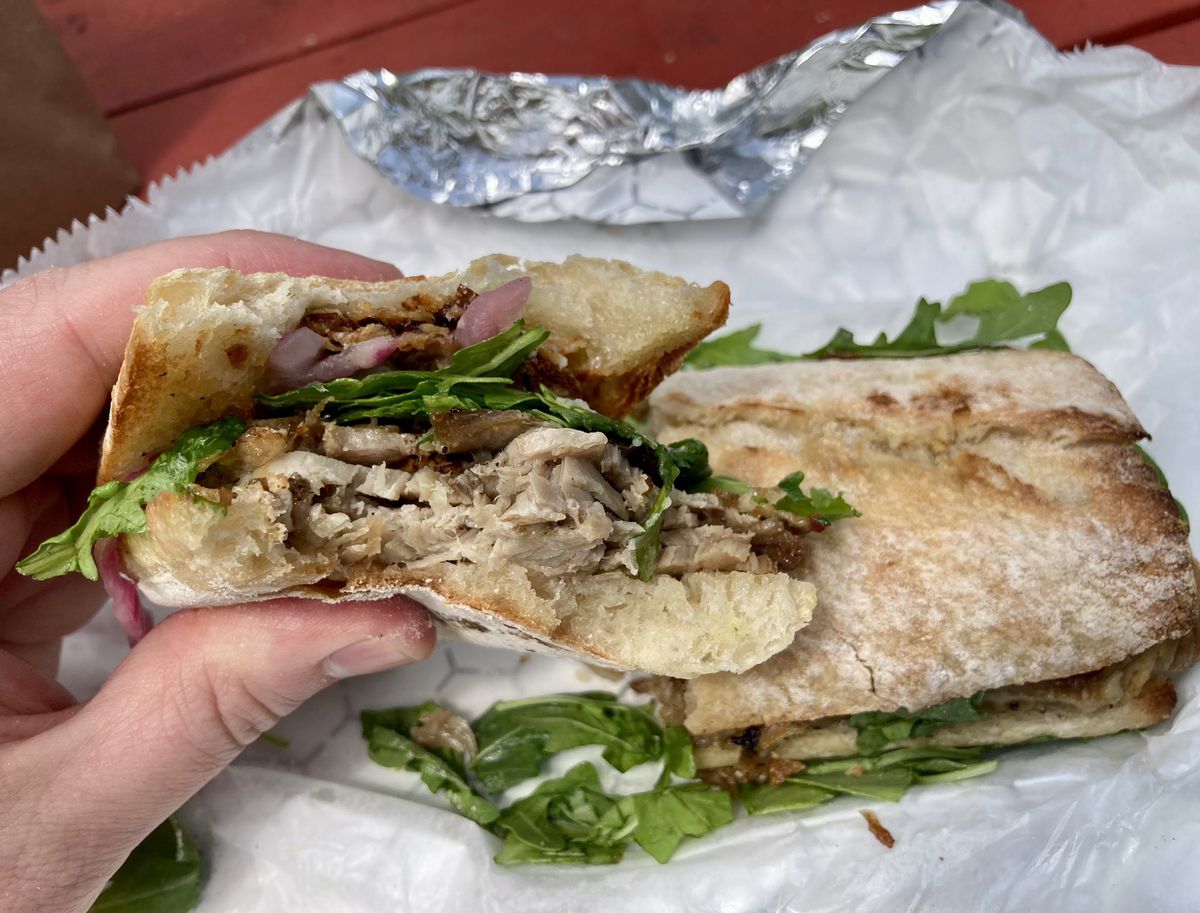 Roast pork sandwich with arugula, pickled red onions, fried lemons, and mayo at Oakhurst Market in Decatur, GA. 