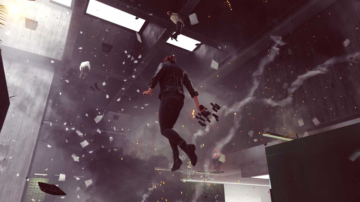 a woman floats in an office, with debris flying everywhere around her