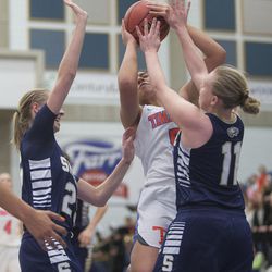 Timpview's Shalyn Fano prepares to put up a shot while guarded by Skyline's Madison Grange (25) and Barrett Jessop (11) during Timpview's 56-49 win over Skyline in the Class 5A state semifinals at Salt Lake Community College in Taylorsville on Friday, Feb. 23, 2018.